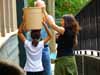 Kimiko and kids carrying water